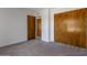 This carpeted bedroom has light walls and wood closet doors at 7530 E North Ln, Scottsdale, AZ 85258
