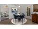 Dining area with seating for four and view of the kitchen and a backyard door at 7530 E North Ln, Scottsdale, AZ 85258