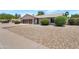 Front yard of home featuring desert landscaping, mature trees and two car garage at 7530 E North Ln, Scottsdale, AZ 85258