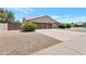Exterior of a well-maintained home with a two-car garage and desert landscaping at 7530 E North Ln, Scottsdale, AZ 85258