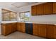 Traditional kitchen with wooden cabinets and a window with natural lighting at 7530 E North Ln, Scottsdale, AZ 85258