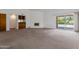 Spacious living room with a fireplace, wet bar, and sliding glass doors to the pool at 7530 E North Ln, Scottsdale, AZ 85258