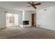 Spacious living room features a fireplace and sliding glass doors to access the outdoor patio at 7530 E North Ln, Scottsdale, AZ 85258