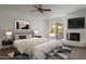 This main bedroom offers a fireplace, ceiling fan and sliding glass doors leading to the patio at 7530 E North Ln, Scottsdale, AZ 85258