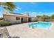 Backyard featuring a pool with a baja step and a covered patio at 7530 E North Ln, Scottsdale, AZ 85258