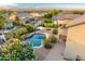 Stunning aerial view of the private backyard featuring a sparkling pool with a rock waterfall feature at 8500 W Nicolet Ave, Glendale, AZ 85305