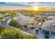 Aerial view showcasing the home's backyard with a patio, landscaped yard, and neighborhood views at 8500 W Nicolet Ave, Glendale, AZ 85305