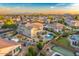 Community aerial view showcasing a home's lush backyard, pool, and neighboring homes with mountain views at 8500 W Nicolet Ave, Glendale, AZ 85305
