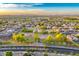 Expansive aerial view showcases a well-maintained neighborhood with lush green spaces and mountain views at 8500 W Nicolet Ave, Glendale, AZ 85305