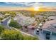 Beautiful sunset aerial view of a neighborhood featuring well-maintained homes and desert landscaping at 8500 W Nicolet Ave, Glendale, AZ 85305