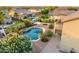 Aerial view highlighting a private backyard pool with waterfall feature, lush landscaping and privacy at 8500 W Nicolet Ave, Glendale, AZ 85305