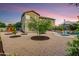 Expansive backyard featuring a swimming pool, patio furniture, and mature landscaping under a twilight sky at 8500 W Nicolet Ave, Glendale, AZ 85305