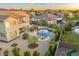 Aerial view of a backyard oasis with a freeform pool, lush landscaping, and patio seating at 8500 W Nicolet Ave, Glendale, AZ 85305
