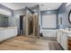 Large bathroom with dual vanities, a standalone tub, and a walk-in shower at 8500 W Nicolet Ave, Glendale, AZ 85305