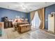 Charming bedroom with wood floors, large windows, and unique decor, creating a cozy and inviting atmosphere at 8500 W Nicolet Ave, Glendale, AZ 85305