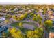 Aerial shot of a neighborhood park featuring a playground, sand volleyball court, and open green spaces at 8500 W Nicolet Ave, Glendale, AZ 85305