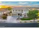Stunning two-story home featuring manicured landscaping, a three-car garage and a lush green lawn at 8500 W Nicolet Ave, Glendale, AZ 85305