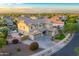 Aerial view of a two story tan house with three car garage, green landscaping, and blue skies at 8500 W Nicolet Ave, Glendale, AZ 85305