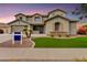 Two-story home showcasing well-manicured lawn and landscaping, three car garage, and neutral exterior at 8500 W Nicolet Ave, Glendale, AZ 85305