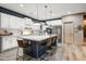 An open kitchen offers a large island with seating, stainless appliances, and modern finishes at 8500 W Nicolet Ave, Glendale, AZ 85305