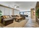 A spacious living room features natural light, comfortable seating, and a view into the kitchen at 8500 W Nicolet Ave, Glendale, AZ 85305