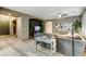 Open living room with hardwood floors, comfortable grey sofa, and a television at 8500 W Nicolet Ave, Glendale, AZ 85305