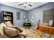 Relaxing living room space with comfortable seating, a keyboard, and guitar against a blue wall at 8500 W Nicolet Ave, Glendale, AZ 85305