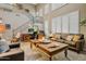 Inviting living room featuring high ceilings, abundant natural light, a staircase, and comfortable seating at 8500 W Nicolet Ave, Glendale, AZ 85305