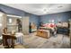 Spacious main bedroom features blue walls, a ceiling fan, light wood floors, and eclectic decor at 8500 W Nicolet Ave, Glendale, AZ 85305