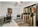 Bright office space with desk, chair, and shelving filled with books and canvases at 8500 W Nicolet Ave, Glendale, AZ 85305