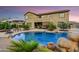 Inviting backyard pool with rock features and desert landscaping provides a serene escape at 8500 W Nicolet Ave, Glendale, AZ 85305