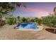 Backyard pool with waterfall feature, surrounded by desert landscaping at 8500 W Nicolet Ave, Glendale, AZ 85305