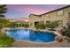 Lush backyard oasis features a sparkling pool, rock features, and mature landscaping at 8500 W Nicolet Ave, Glendale, AZ 85305