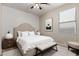 Comfortable bedroom with neutral tones, large window, ceiling light, and minimalist decor at 8848 W Cordes Rd, Tolleson, AZ 85353