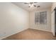 Neutral bedroom with a window, ceiling fan, and tile flooring at 8848 W Cordes Rd, Tolleson, AZ 85353