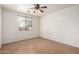Empty bedroom with a ceiling fan and a window letting in natural light at 8848 W Cordes Rd, Tolleson, AZ 85353