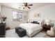 Bright bedroom featuring a ceiling fan, plush bedding, a window with blinds, and neutral décor at 8848 W Cordes Rd, Tolleson, AZ 85353