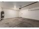 A large garage with lots of open space, a water heater and an exit door at 8848 W Cordes Rd, Tolleson, AZ 85353