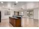 Bright kitchen features an island with sink, dishwasher, and open floor plan at 8848 W Cordes Rd, Tolleson, AZ 85353