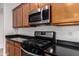 Close-up of the kitchen featuring modern appliances, a gas range, and black countertops, perfect for cooking enthusiasts at 8848 W Cordes Rd, Tolleson, AZ 85353