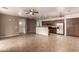 Bright, open-plan living area with tile floors, ceiling fan, and views of the kitchen and dining area at 8848 W Cordes Rd, Tolleson, AZ 85353