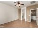 Main bedroom features ceiling fan, tiled floor, and ensuite bathroom and closet at 8848 W Cordes Rd, Tolleson, AZ 85353