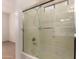 Ensuite bathroom shower and bathtub combo with glass doors and tile surround at 8848 W Cordes Rd, Tolleson, AZ 85353