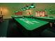Recreational billiards room with four pool tables, green covers, and vintage lighting at 9302 E Broadway Rd # 157, Mesa, AZ 85208