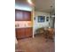 A dining room featuring brown cabinets, neutral tile flooring, and traditional furnishings at 9302 E Broadway Rd # 157, Mesa, AZ 85208