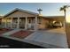 A charming home with a covered front porch, desert landscaping and a carport at 9302 E Broadway Rd # 157, Mesa, AZ 85208