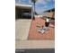 A front yard with desert landscaping, a carport, and decorative yard sculptures at 9302 E Broadway Rd # 157, Mesa, AZ 85208