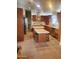 Kitchen featuring stainless steel appliances, brown cabinets, a kitchen island, and neutral tile flooring at 9302 E Broadway Rd # 157, Mesa, AZ 85208