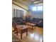 Comfortable living room featuring hardwood floors, neutral paint, and comfortable, dark sofa seating at 9302 E Broadway Rd # 157, Mesa, AZ 85208