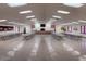 Large, well-lit meeting room with rows of tables, large screen TV, and ample space for gatherings at 9302 E Broadway Rd # 157, Mesa, AZ 85208